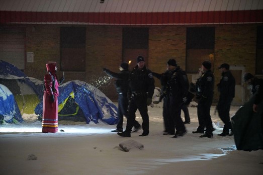 Police raid on encampment at Roof Depot building site.