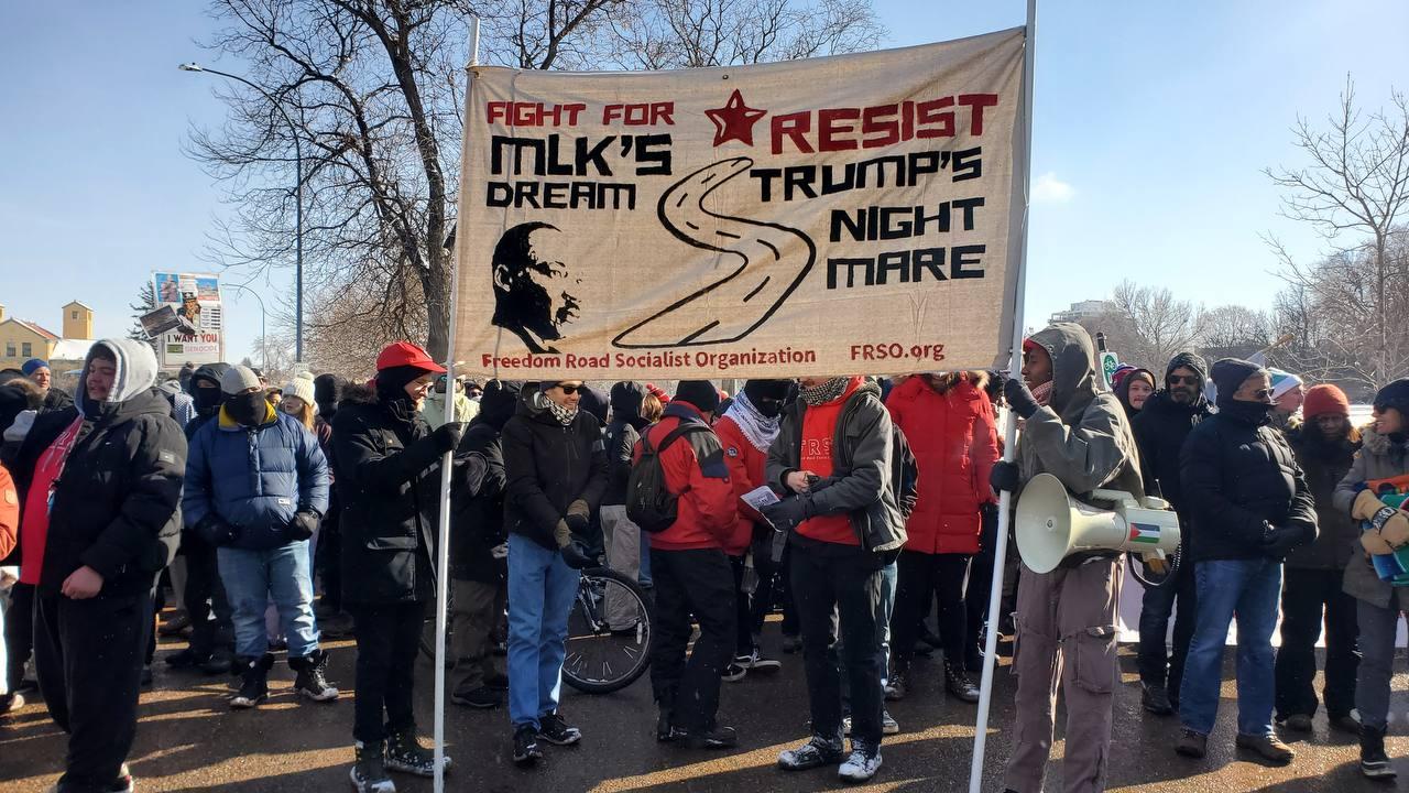 A group of protesters holding a banner