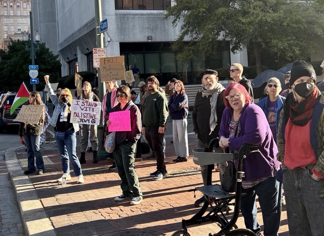 A crowd of people holding signs.