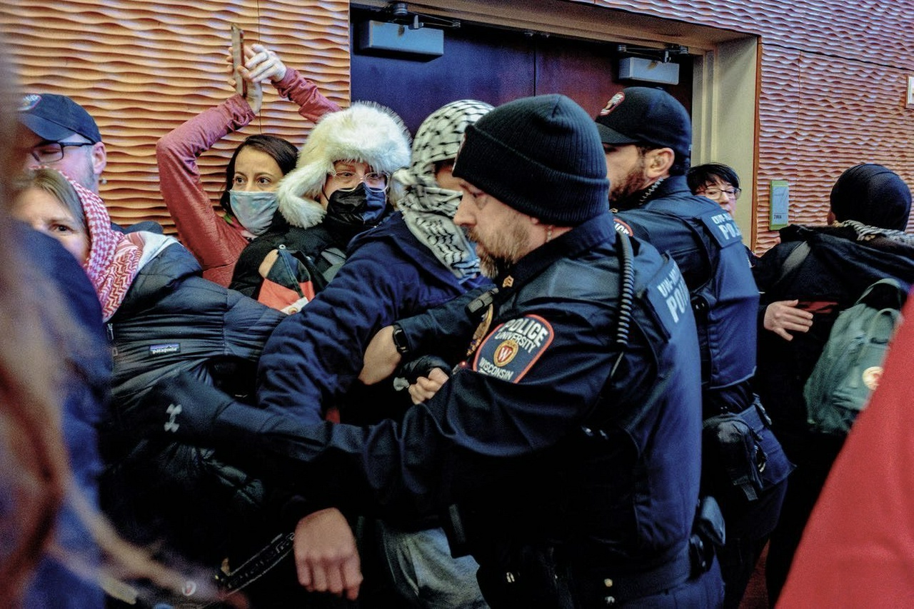 Police arresting a group of pro-Palestine protesters.