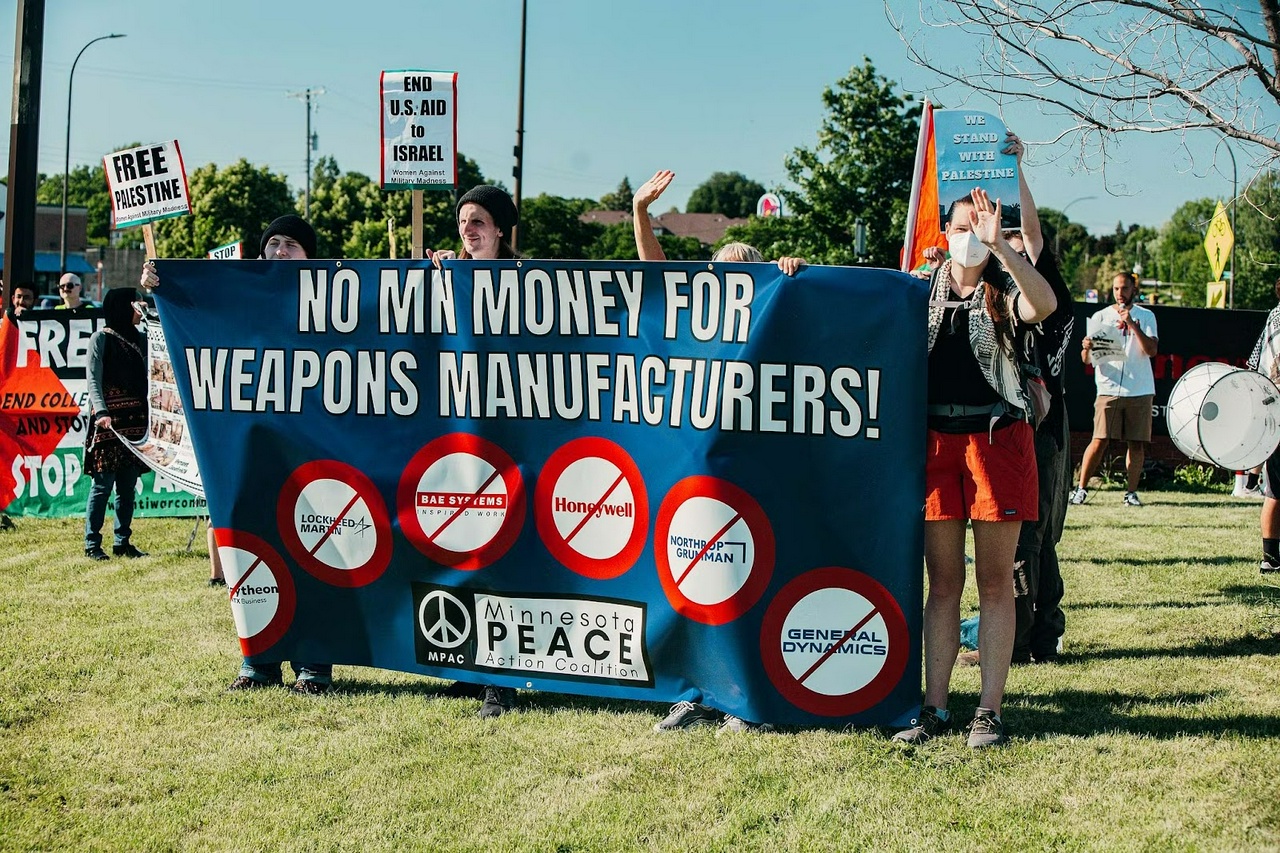 No Minnesota money for weapons manufacturers banner at Honeywell Aerospace protest.  | Ashley Taylor-Gougé/watch me rise mpls