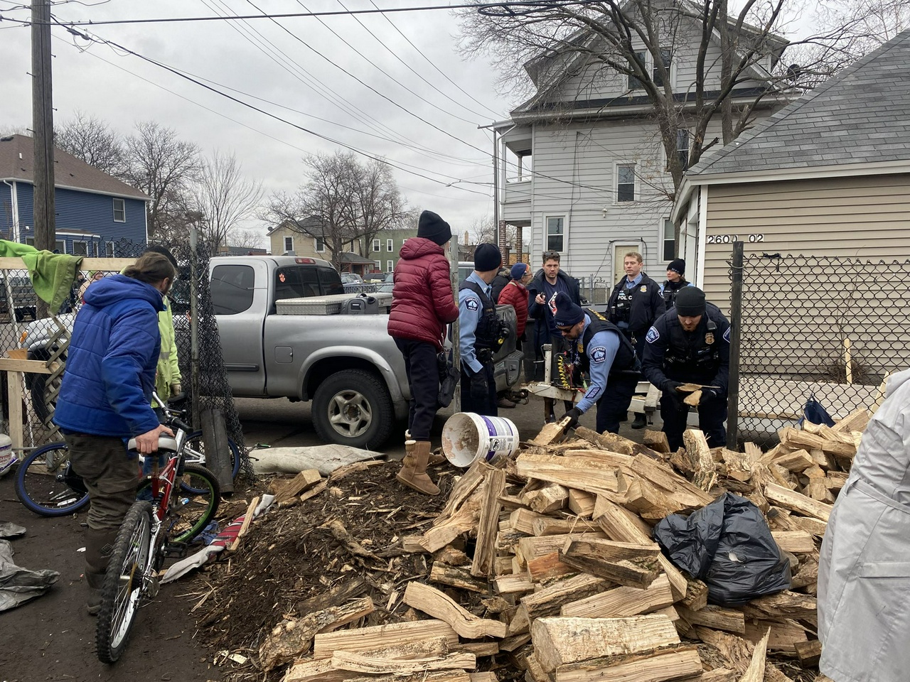 Minneapolis police taking firewood from Nenookaasi Healing Camp. | Fight Back! News/staff