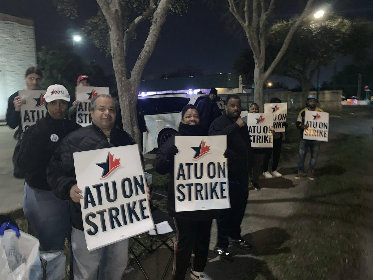 A group of people holding signs reading, "ATU on Strike"