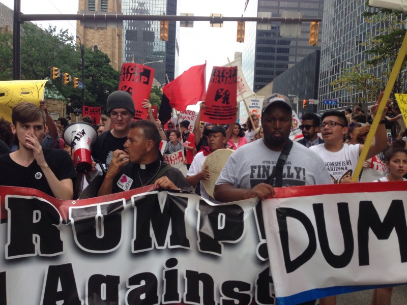 Padre José Landaverde leading chants on the march on the RNC