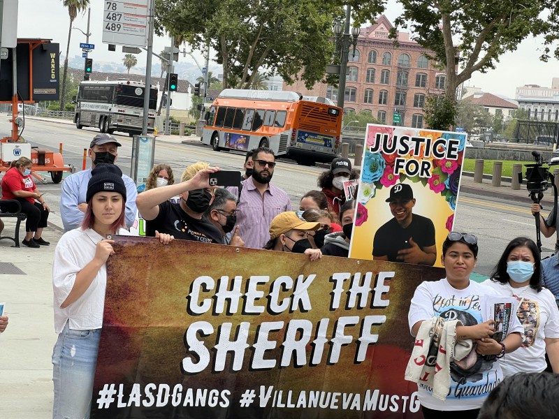 Members of the Check the Sheriff Coalition with families who have lost their s