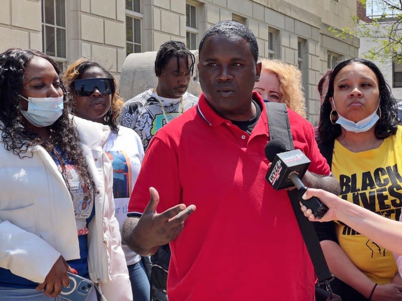 Caption can read: Anthony Gay outside Peoria Federal Court House with supporters