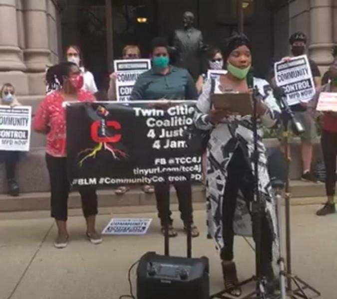 Danielle Burns, sister of Jamar Clark, at the microphone, Loretta VanPelt and Ja