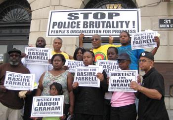 Photo of the People's Organization for Progress holding protest signs.