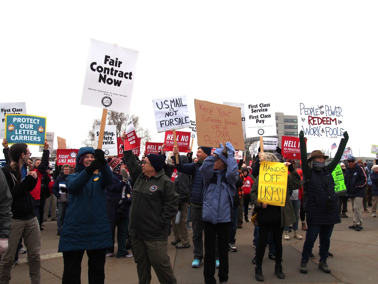 A group of postal workers holding signs.