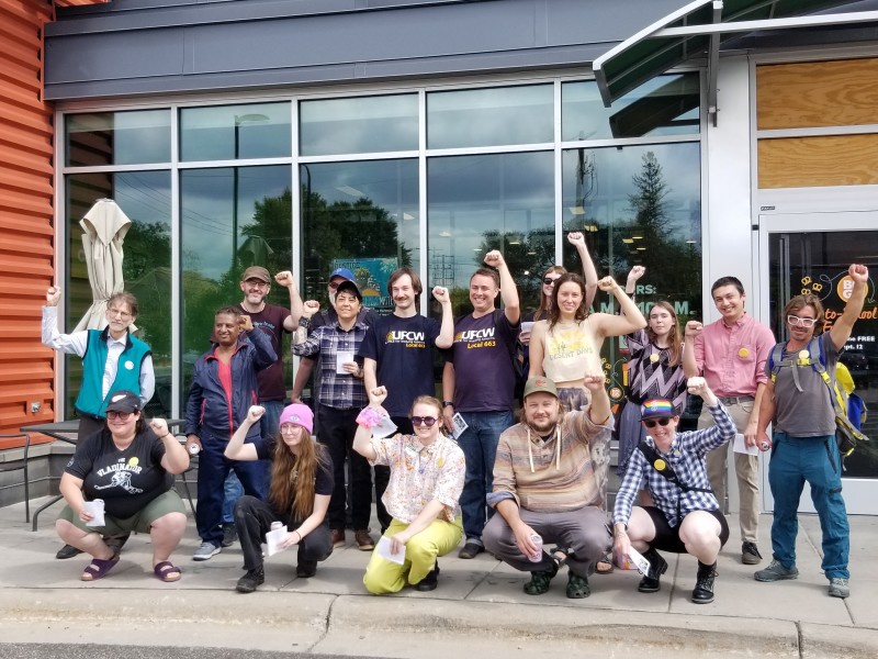 Seward workers gather outside the store’s Friendship location to leaflet custome