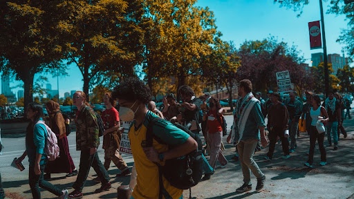 University of Illinois Chicago \[UIC\] students marching towards the Reserve Officers’ Training Corps building \[ROTC\]. |  Baitul Javid