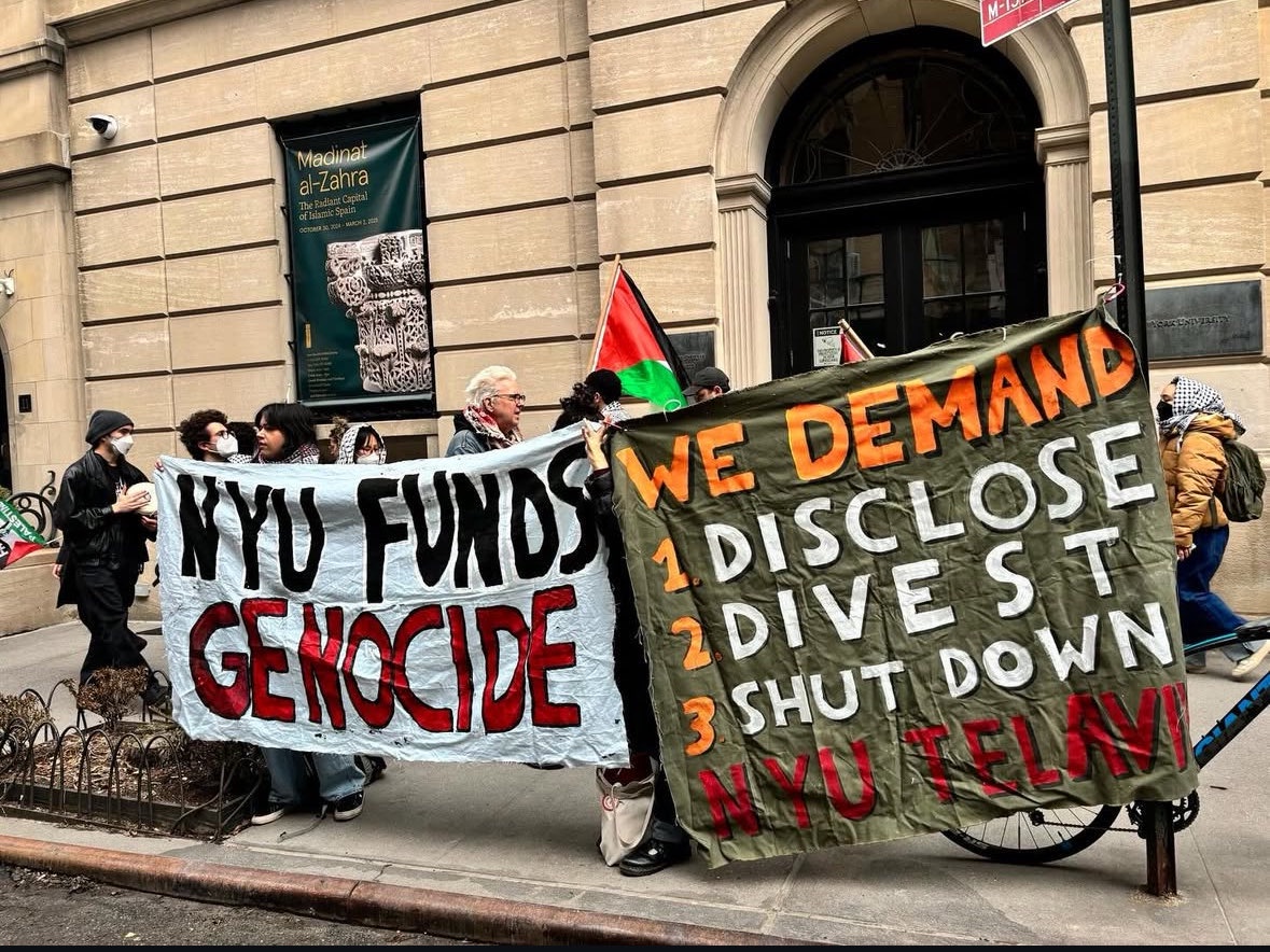 Protesters hold banners that read “NYU FUNDS GENOCIDE” and “WE DEMAND 1. DISCLOSE 2. DIVEST 3. SHUT DOWN NYU TEL AVIV”.