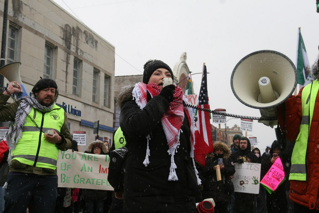 Gabriela Hernández Chico, a leader of Casa DuPage Workers Center, speaking at the close of the two-mile march through Little Village.
