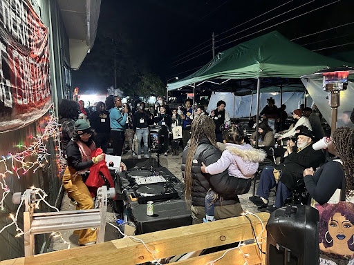 A political rally on a sidewalk with many people.