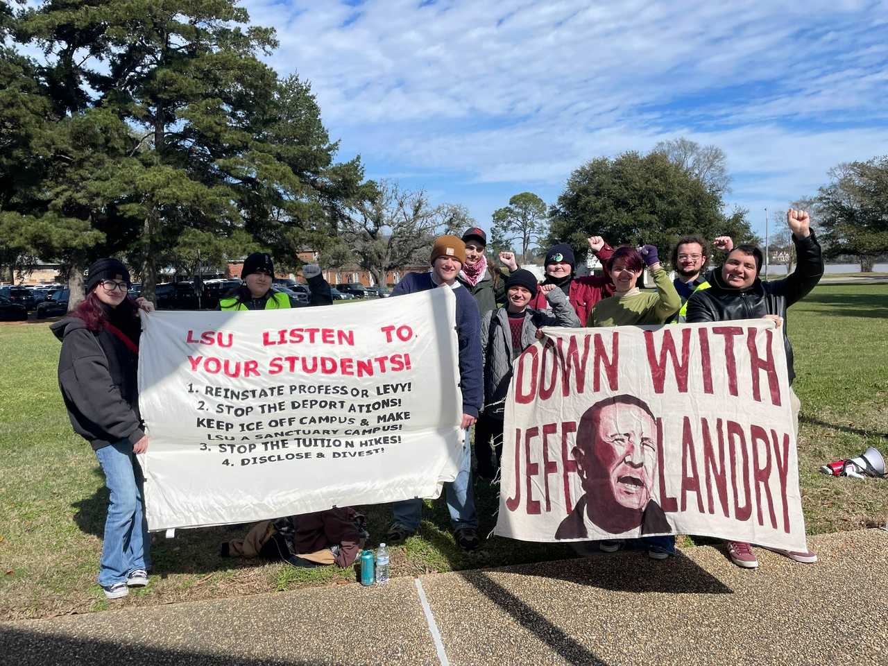 LSU students hold banners with their demands.