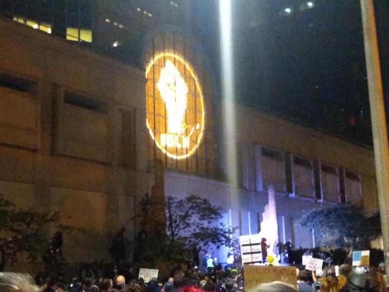 Thousands rally for Black lives, July 31, in Portland. "BLM" with fist was proje