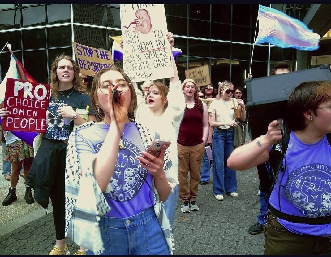 Organizers with the Queer and Trans Community Action Project lead the march onto the streets in downtown New Orleans.