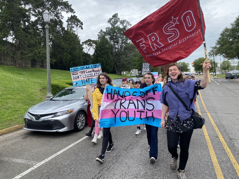 Protesters march down Capitol Access Road.