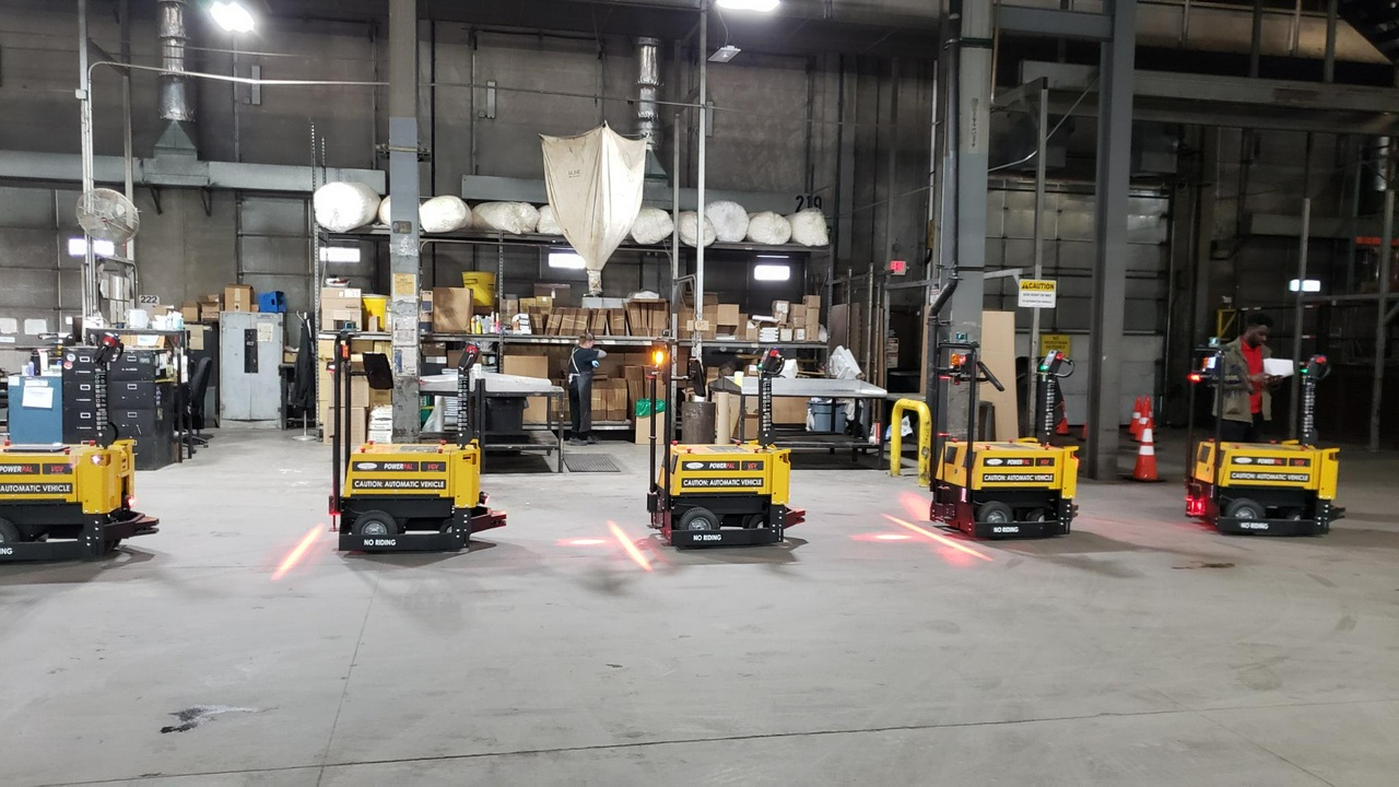 A row of unused automated tug machines sit in a UPS warehouse facility.