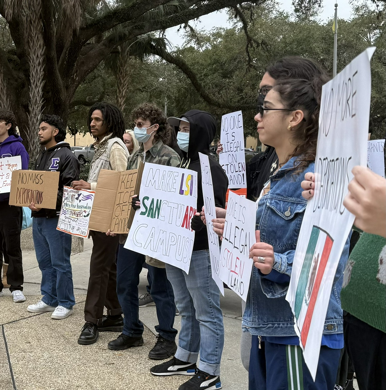 Student protesters hold signs denouncing mass deportations, call for a sanctuary campus at LSU. 