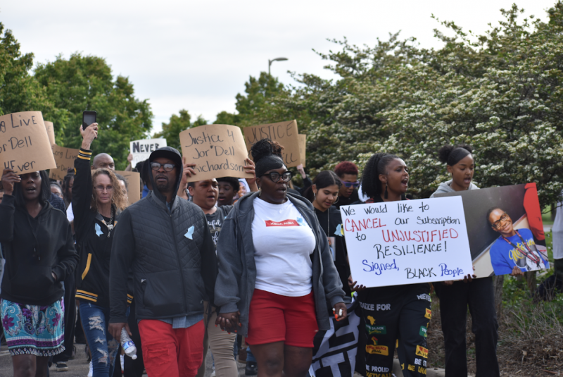 Laurie Littlejohn, along with family members and supporters, marches for account