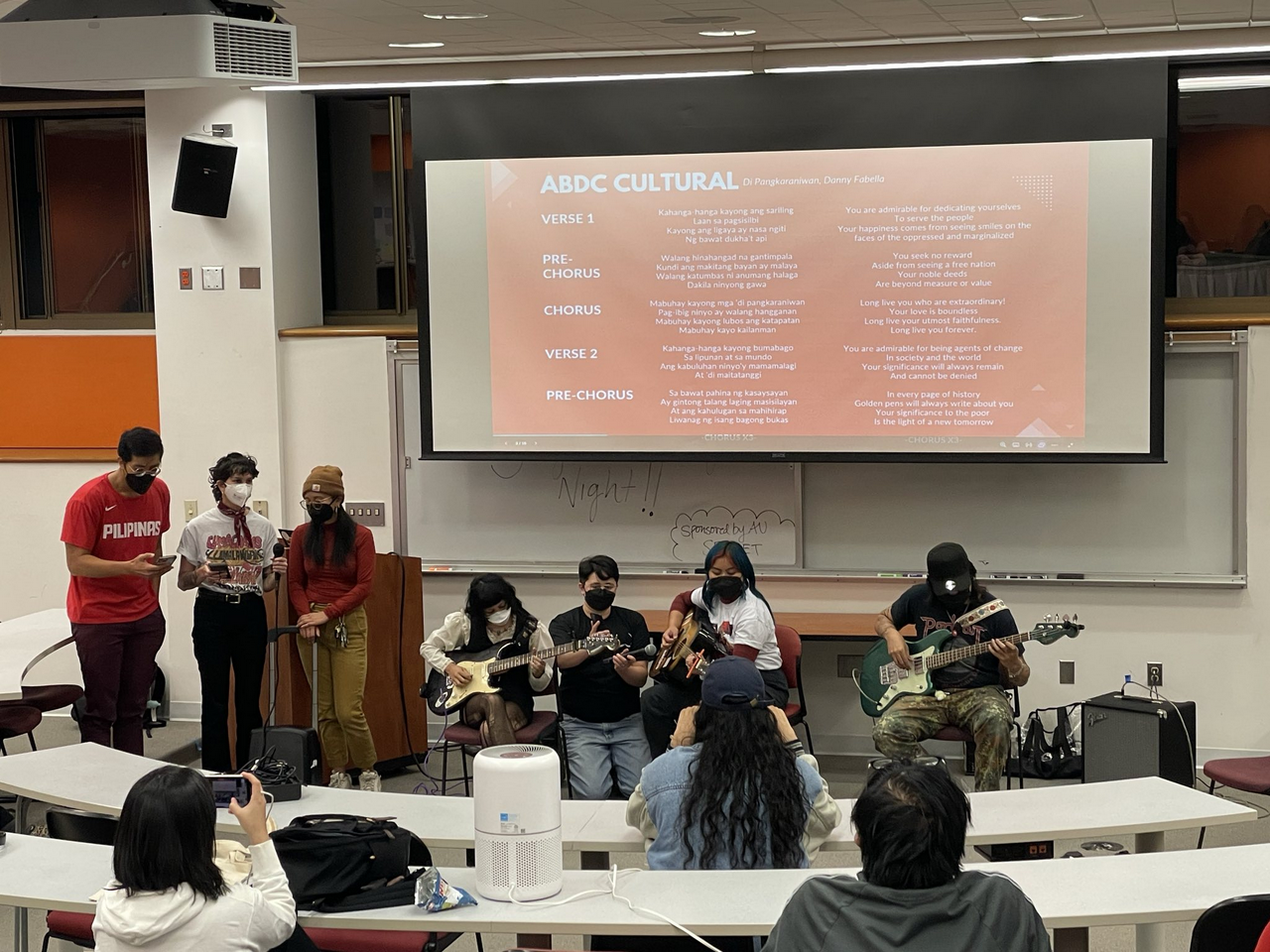 A group of people perform music for an audience.